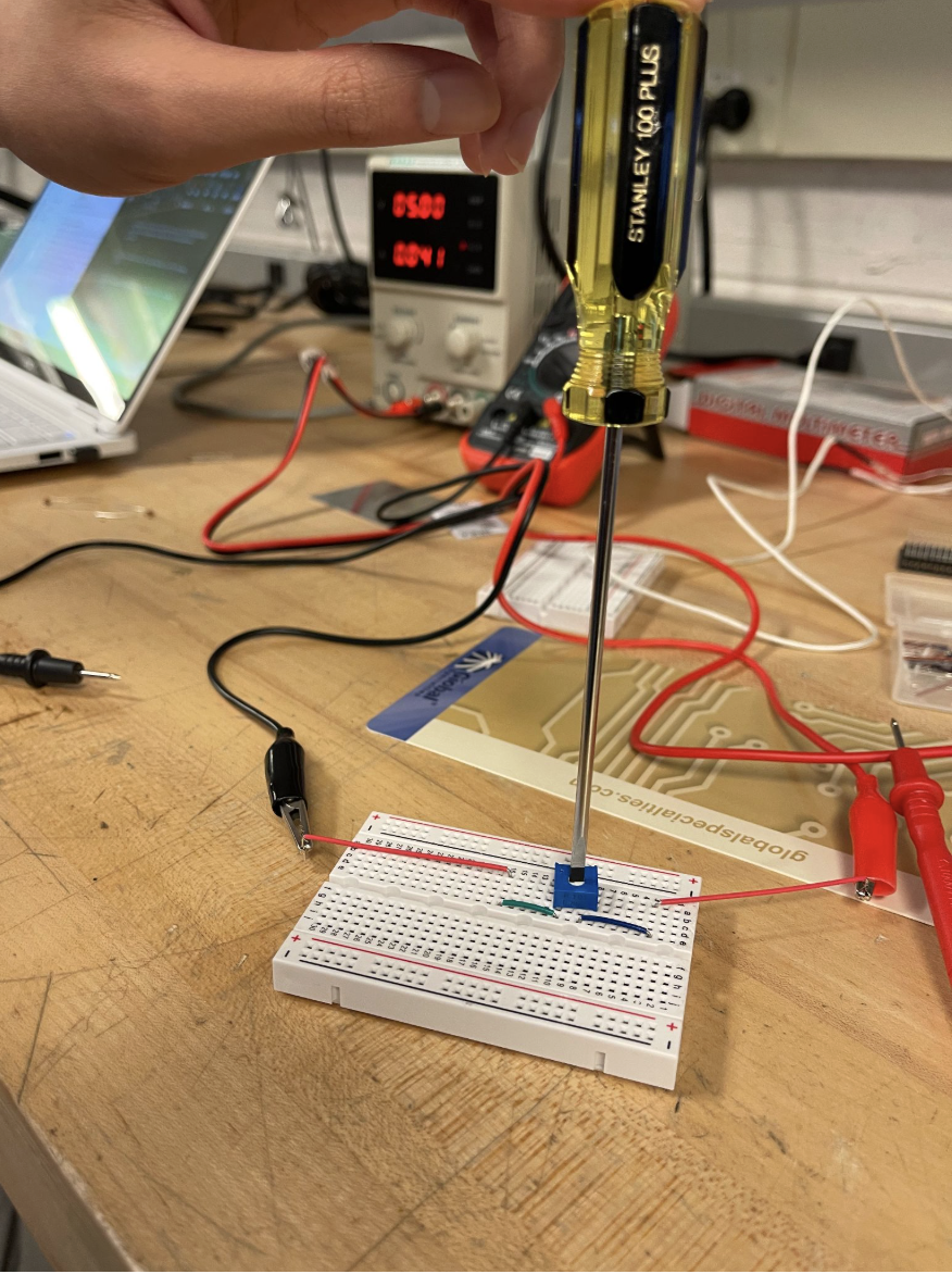 Potentiometer wired on a breadboard and adjusted with a screwdriver