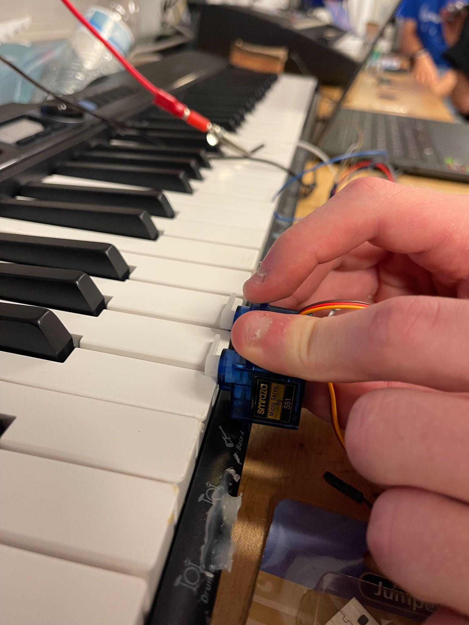 Early servo keypress testing for a robotic piano player